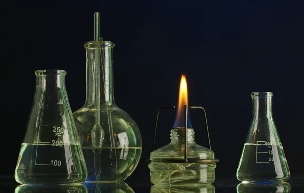 Spiritlamp and test-tubes on blue background — Stock Photo, Image