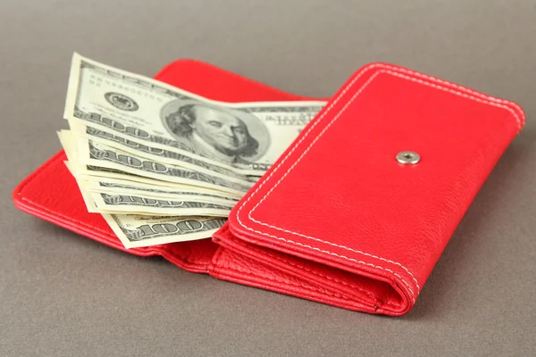 Purse with hundred dollar banknotes, on color background — Stock Photo, Image