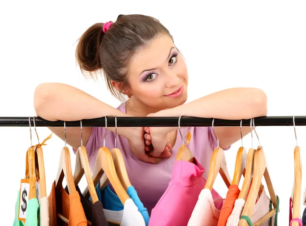 Chica joven comprando ropa aislada en blanco — Foto de Stock