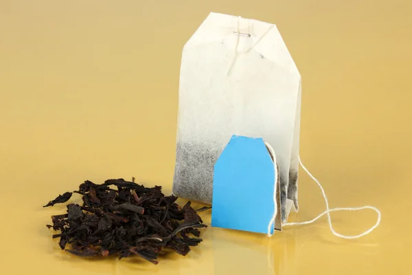 Tea bag on yellow background — Stock Photo, Image