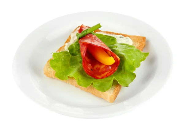 Salami rolls with paprika pieces inside, on roasted bread, isolated on white — Stock Photo, Image