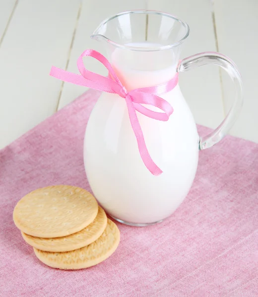 Pitcher of milk on table in room — Stock Photo, Image
