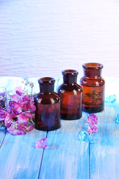 Spa oil and freesia on light background — Stock Photo, Image