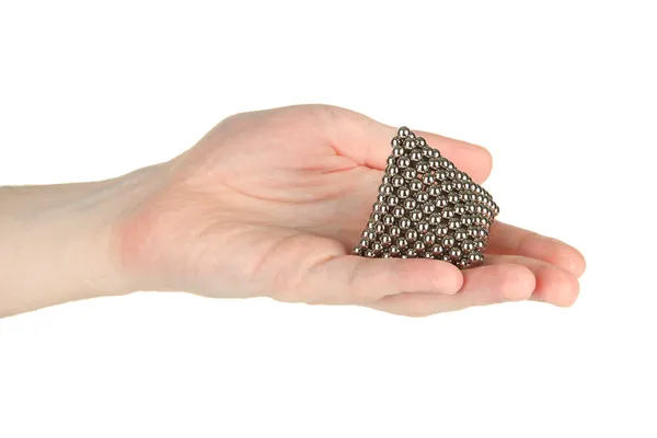 Pyramid of metal balls for neocube (toy) on man hand, isolated on white — Stock Photo, Image