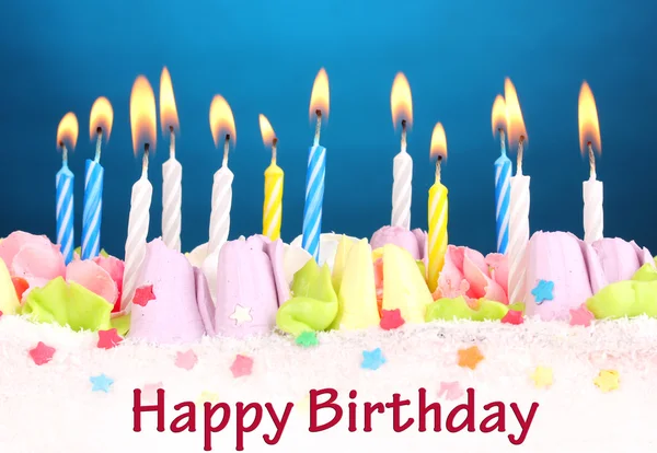 Birthday cake with candles on blue background — Stock Photo, Image