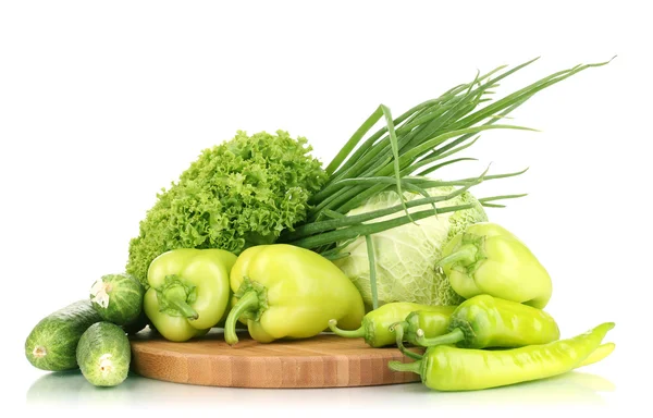 Fresh green vegetables on chopping board isolated on white — Stock Photo, Image