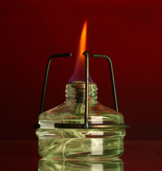 Spiritlamp on red background — Stock Photo, Image