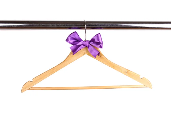 Beautiful purple bow hanging on wooden hanger isolated on white — Stock Photo, Image