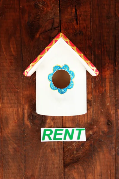 Decorative nesting box and sign on wooden background — Stock Photo, Image