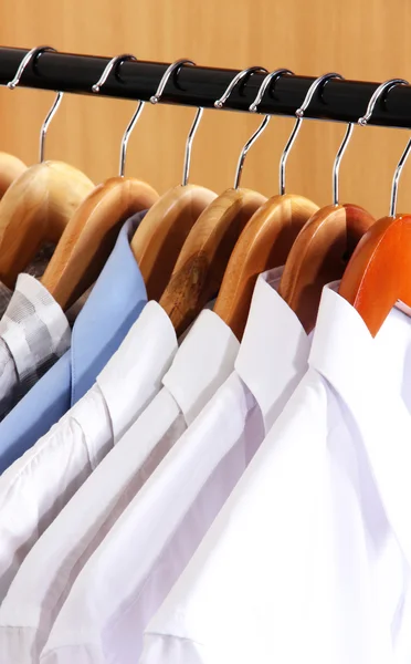 Men's shirts on hangers in wardrobe — Stock Photo, Image