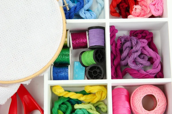 Material for embroidery in white wooden box closeup — Stock Photo, Image