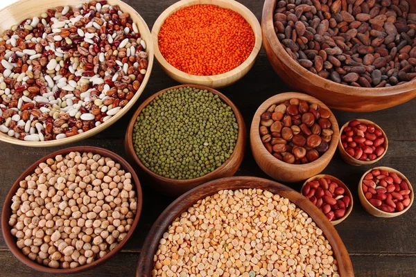 Different kinds of beans in bowls on table close-up — Stock Photo, Image
