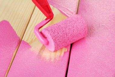 rulo fırça ahşap zemin üzerinde pembe boya ile boyayın.