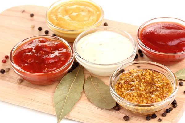 Various sauces on chopping board close-up — Stock Photo, Image