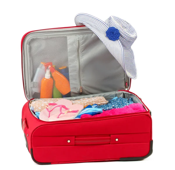 Suitcase with summer clothes, a hat and suntan isolated on white — Stockfoto