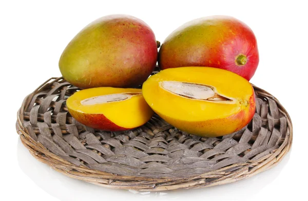 Ripe appetizing mango on wicker cradle isolated on white — Stock Photo, Image