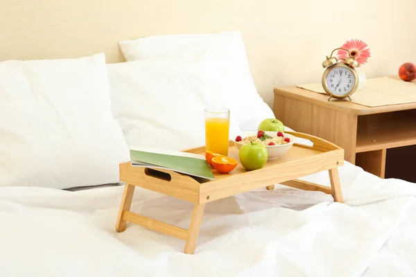 Wooden tray with light breakfast on bed — Stock Photo, Image