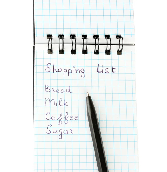 Lista de compras em um caderno sobre fundo branco close-up — Fotografia de Stock