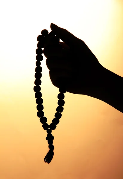 Female hands with rosary, on beige background — Stock Photo, Image