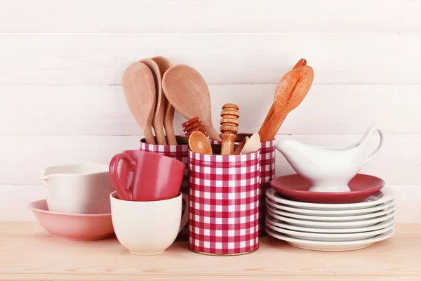 Cups, bowls nd other utensils in metal containers isolated on light background — Stock Photo, Image