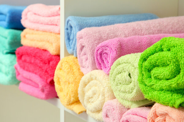 colorful towels on shelves in bathroom