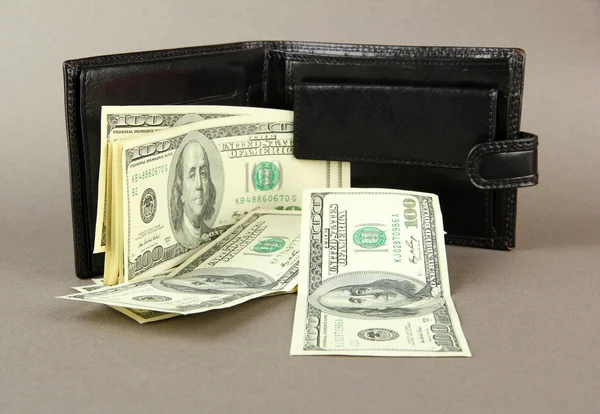 Wallet with hundred dollar banknotes, on color background — Stock Photo, Image