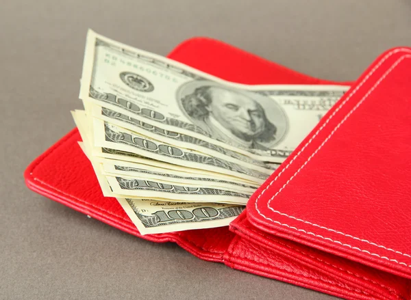 Purse with hundred dollar banknotes, on color background — Stock Photo, Image