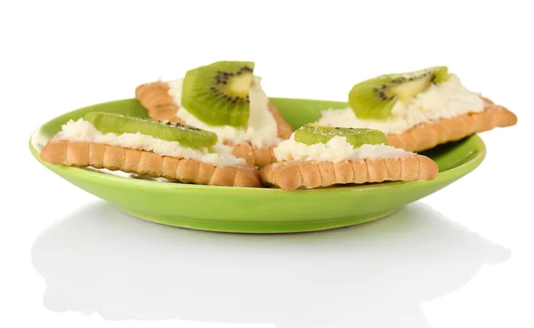 Canapes with cheese and kiwi, on color plate, isolated on white — Stock Photo, Image