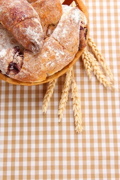 Taste croissants in basket on tableclot — Stock Photo, Image