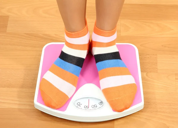 Feet on scales on floor in room — Stock Photo, Image