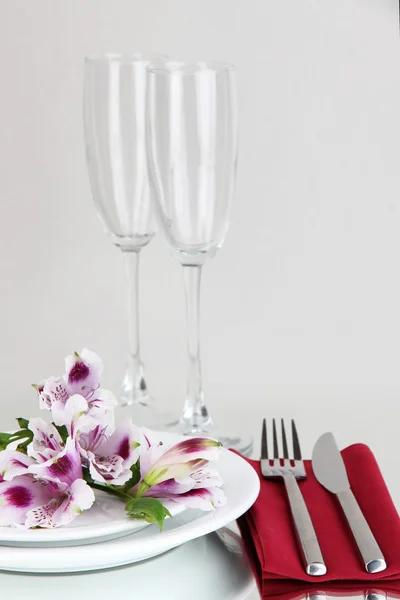 Configuração de mesa festiva com flores no fundo cinza — Fotografia de Stock