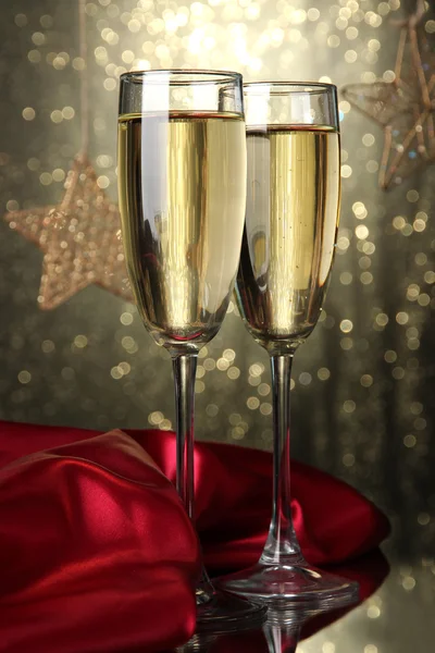 Two glasses of champagne on bright background with lights — Stock Photo, Image