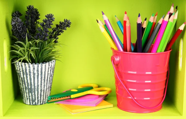 Colorful pencils in pail on shelf on wooden background — Stock Photo, Image