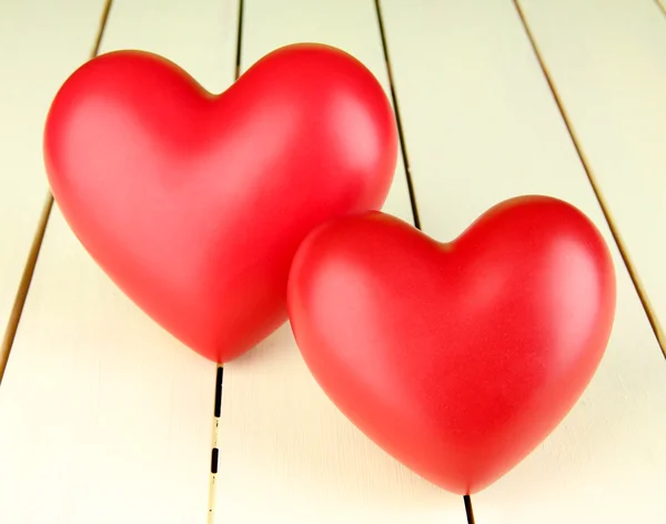 Decorative red hearts on color wooden background — Stock Photo, Image