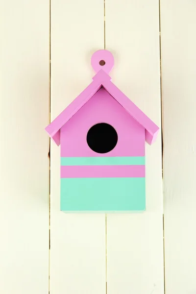 Decorative nesting box on color wooden background — Stock Photo, Image