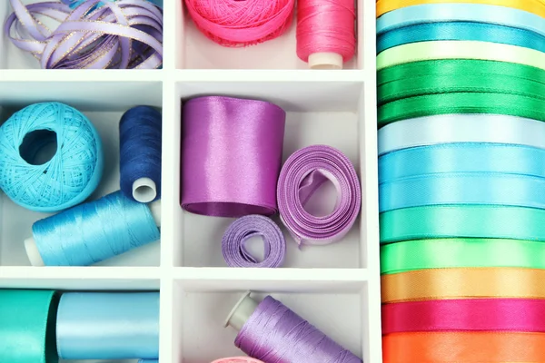 Material for sewing in white wooden box closeup — Stock Photo, Image