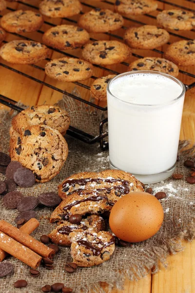 Chocolate cookies on the baking with glass of milk close up — Stock Photo, Image