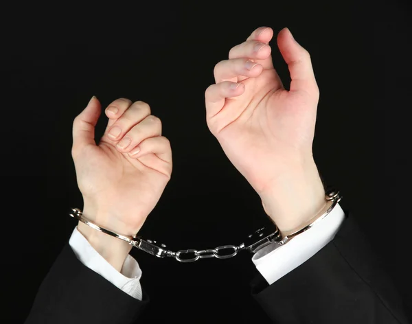 Man and woman hands and breaking handcuffs isolated on black background — Stock Photo, Image