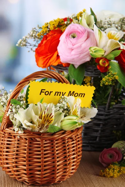 Many different flowers in baskets on room background — Stock Photo, Image