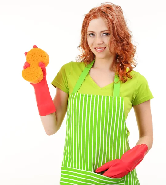Young woman wearing green apron and rubber gloves with sponge, isolated on white — Stock Photo, Image