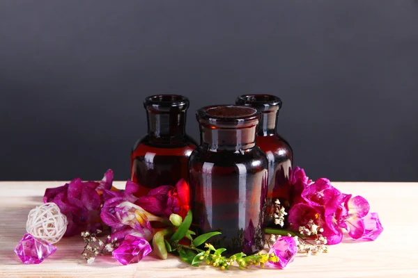 Spa oil and freesia on gray background — Stock Photo, Image