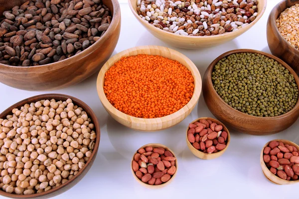 Different kinds of beans in bowls close-up — Stock Photo, Image