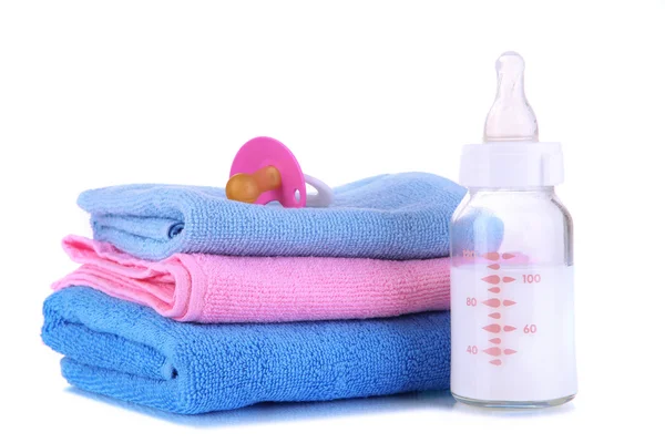 Bottle for milk with towels and nipple isolated on white — Stock Photo, Image