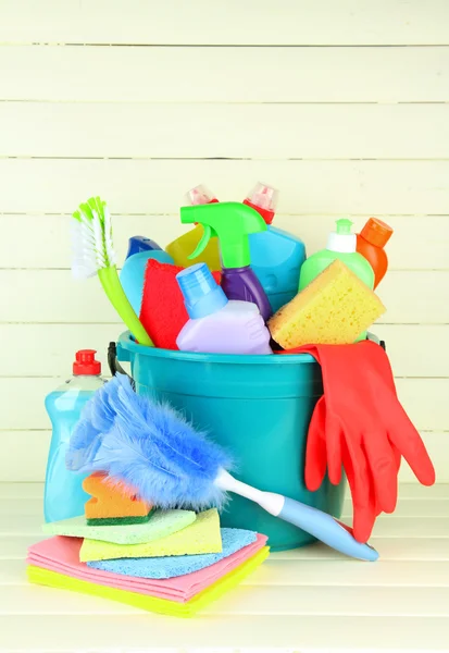 Cleaning items in bucket on white wooden background — Stock Photo, Image