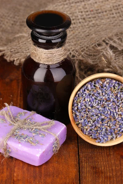 Flores y frasco de lavanda — Foto de Stock