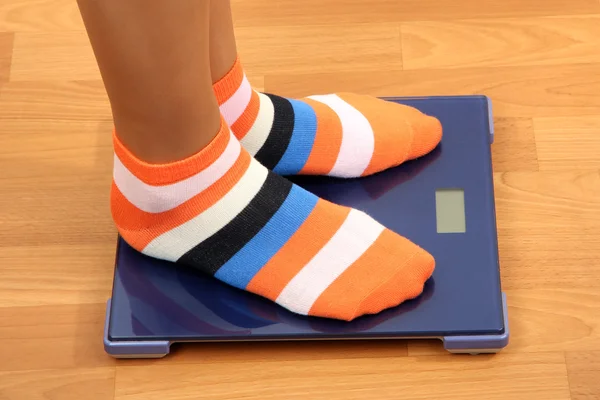 Feet on scales on floor in room — Stock Photo, Image