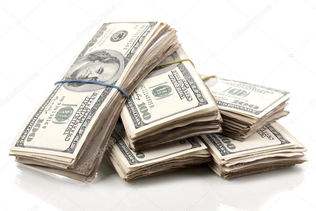 Stacks of one hundred dollars banknotes close-up isolated on white