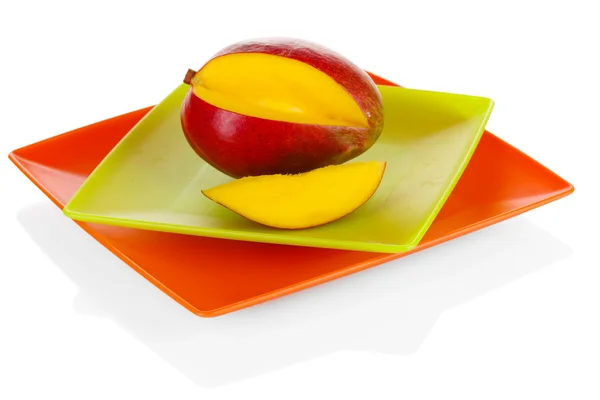 Ripe appetizing mango on red plate isolated on white — Stock Photo, Image