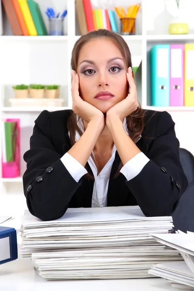 Sad business woman with documents in her workplace — Stock Photo, Image