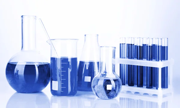 Test tubes with colorful liquids in blue light — Stock Photo, Image